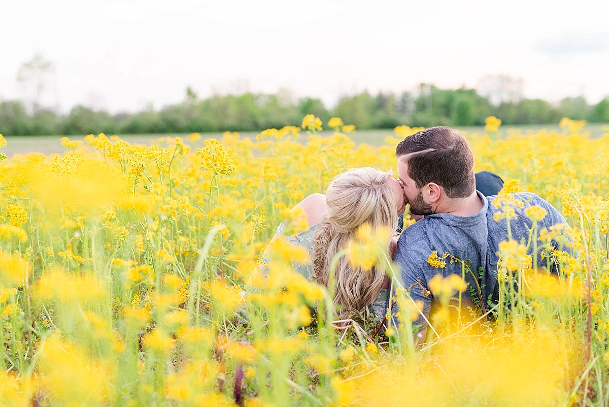Couple laying in yellow flowers