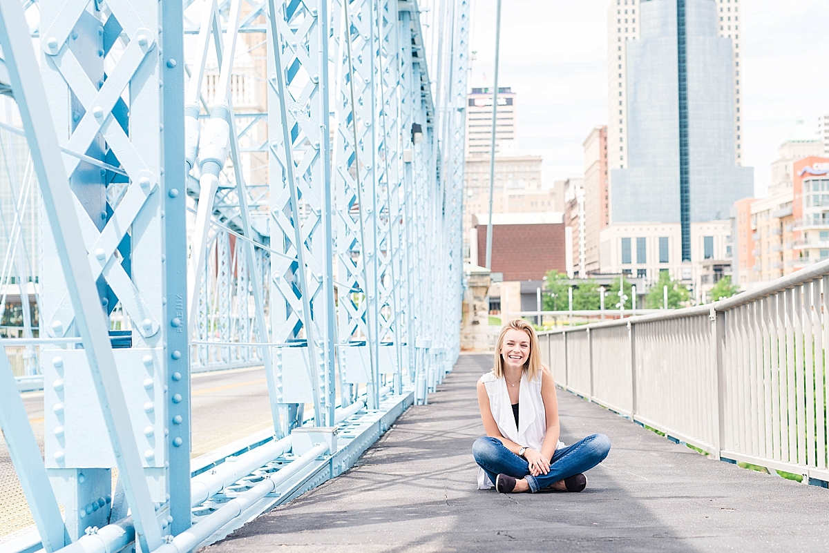 Senior girl sitting on a bridge